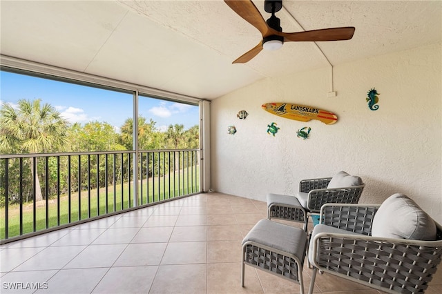 sunroom featuring ceiling fan and vaulted ceiling