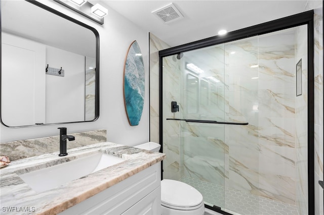 full bathroom featuring a marble finish shower, visible vents, vanity, and toilet