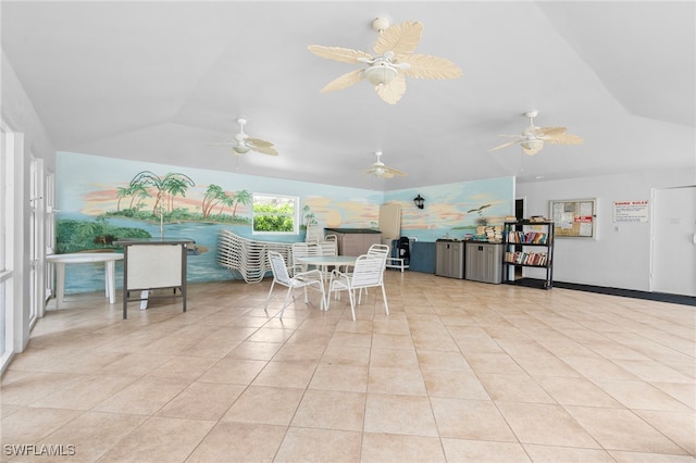 dining area featuring vaulted ceiling and light tile patterned flooring