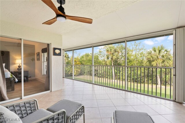 sunroom / solarium featuring ceiling fan