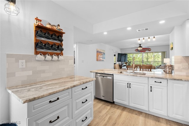 kitchen featuring a sink, visible vents, white cabinets, stainless steel dishwasher, and light wood-type flooring