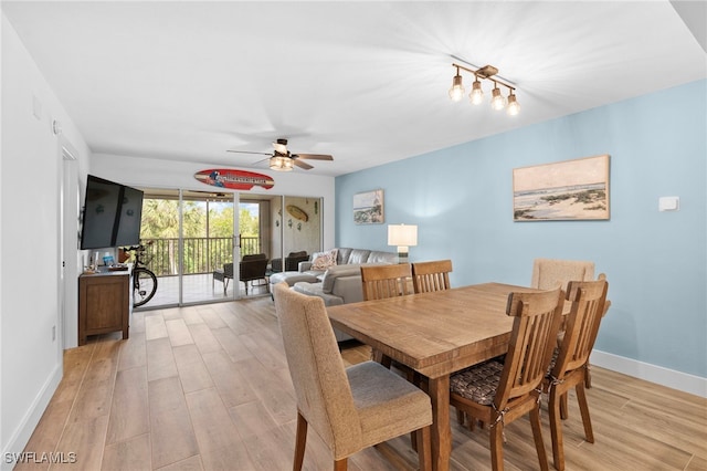 dining space with ceiling fan, light wood-style flooring, and baseboards