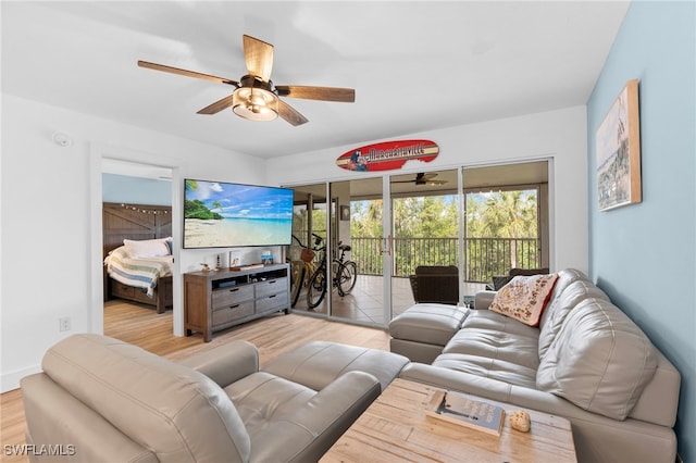 living room featuring ceiling fan and wood finished floors