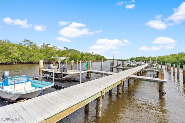 dock area with a water view and boat lift