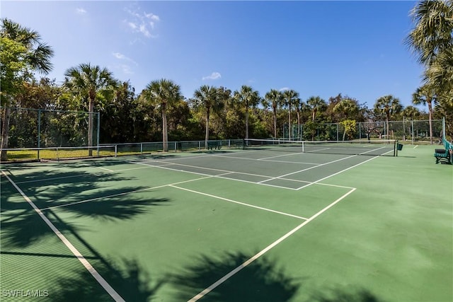 view of sport court featuring fence