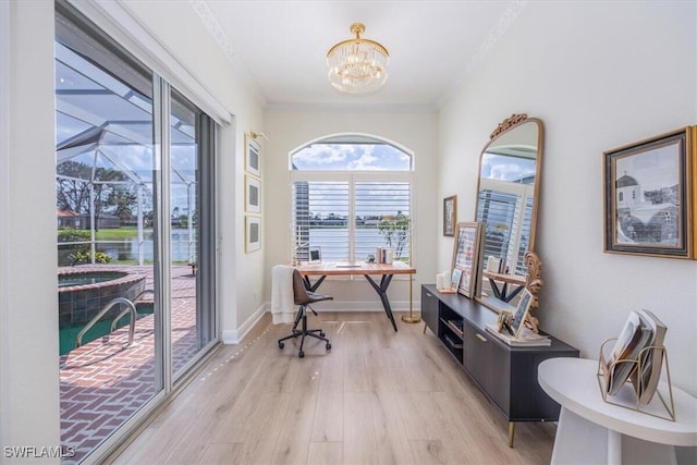 home office with light hardwood / wood-style flooring, a water view, a chandelier, and crown molding