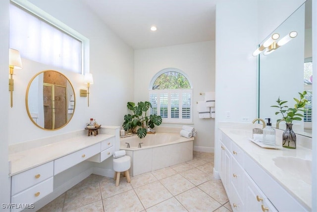 bathroom featuring plus walk in shower, vanity, and tile patterned flooring