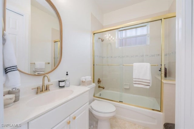 full bathroom featuring tile patterned flooring, enclosed tub / shower combo, toilet, and vanity