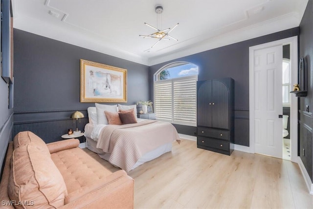 bedroom featuring ornamental molding and light hardwood / wood-style flooring