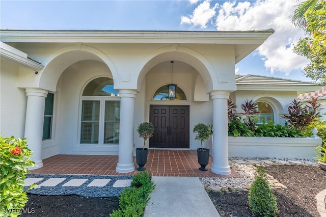 view of exterior entry with covered porch