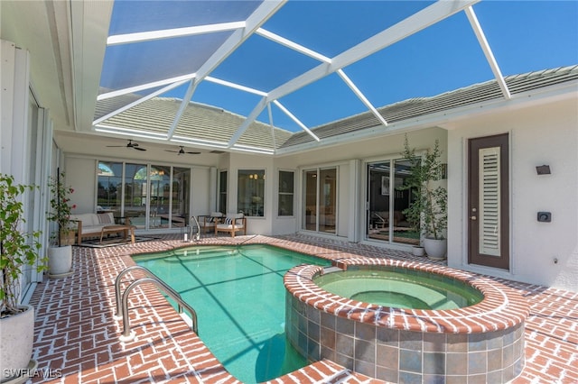 view of swimming pool featuring a lanai, ceiling fan, a patio, and an in ground hot tub