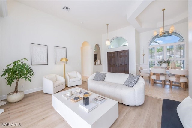 living room featuring a chandelier and light hardwood / wood-style floors