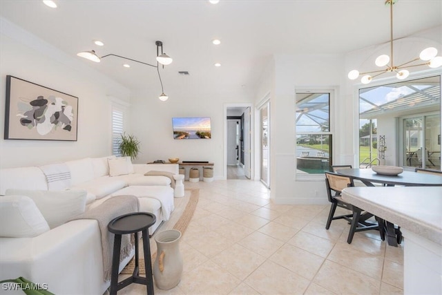 living room with light tile patterned floors and a notable chandelier