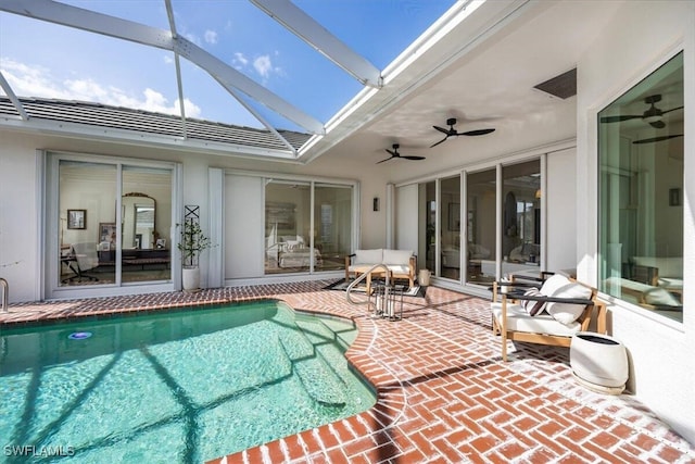 view of swimming pool with a lanai, ceiling fan, and a patio