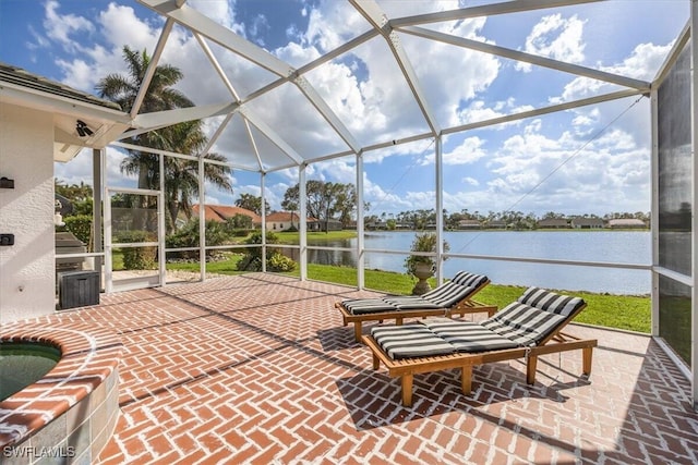 sunroom featuring a water view