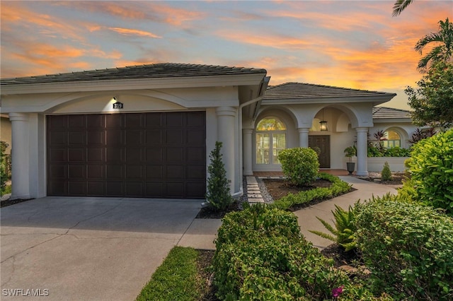 mediterranean / spanish home with a garage