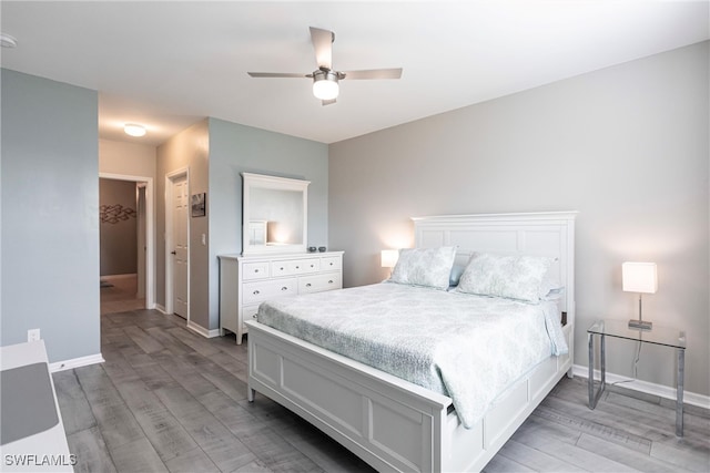 bedroom featuring ceiling fan, a closet, and light hardwood / wood-style flooring