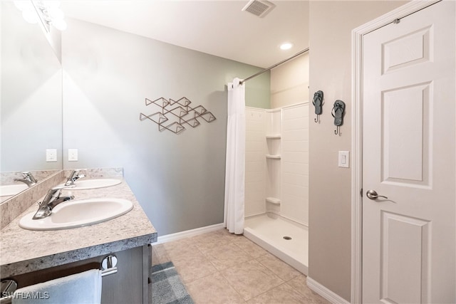 bathroom with tile patterned floors, curtained shower, and vanity