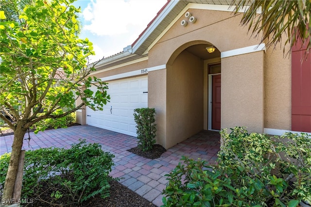 view of exterior entry featuring a garage