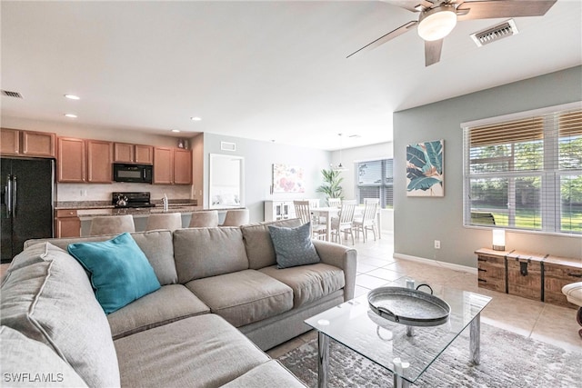 tiled living room featuring ceiling fan