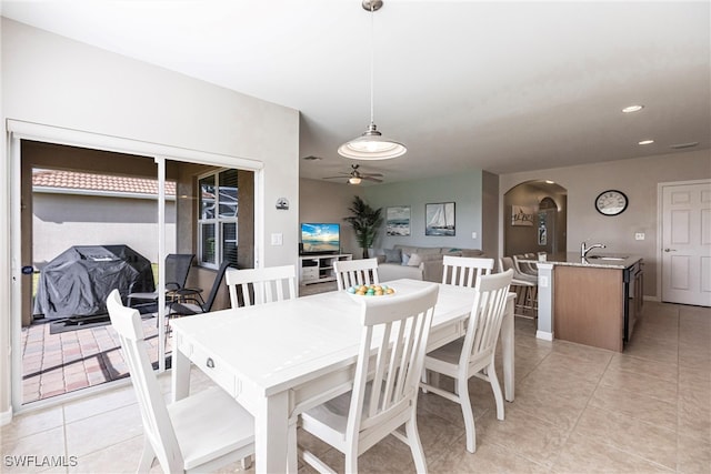 dining area with ceiling fan, sink, and light tile patterned floors