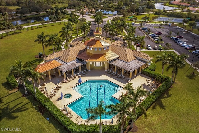 view of swimming pool with a patio and a water view