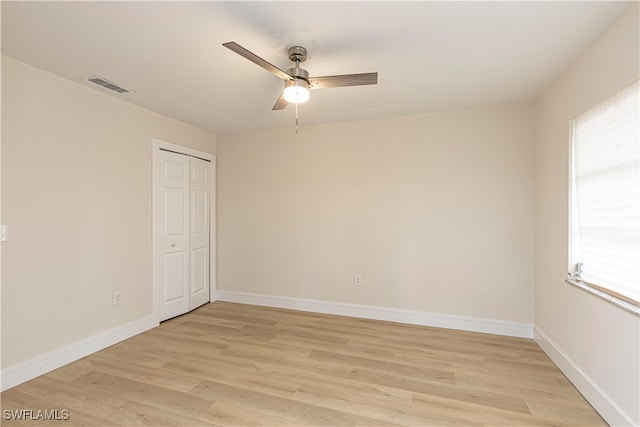 unfurnished room with visible vents, baseboards, a ceiling fan, and light wood finished floors