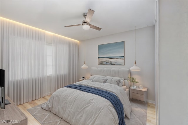 bedroom with ceiling fan and light wood-type flooring