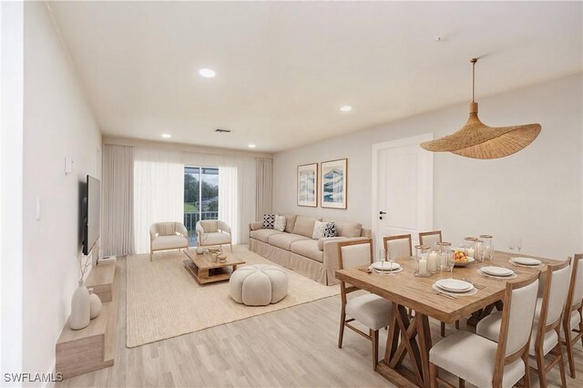 living area with visible vents, recessed lighting, and light wood-style floors