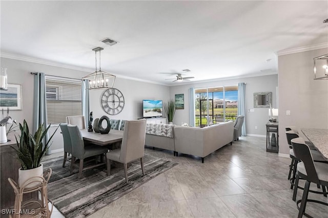 dining area with baseboards, ceiling fan with notable chandelier, visible vents, and crown molding