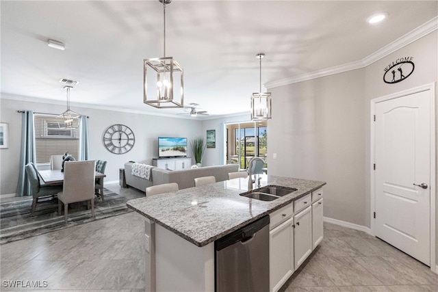 kitchen featuring a center island with sink, dishwasher, decorative light fixtures, white cabinetry, and a sink