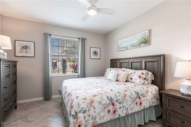 bedroom with ceiling fan, baseboards, and light tile patterned floors