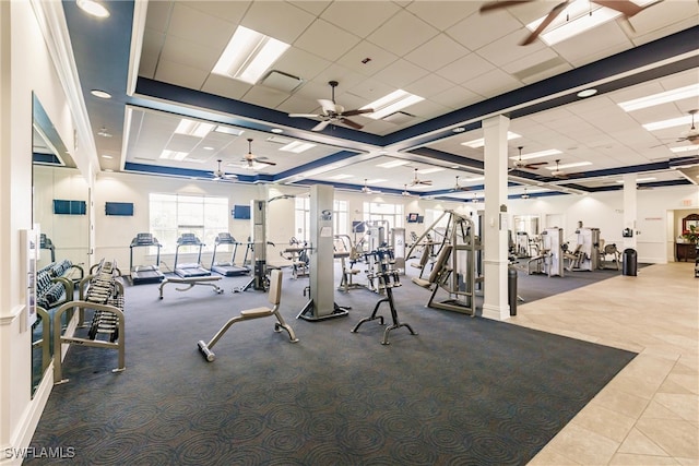 gym featuring a drop ceiling and a ceiling fan