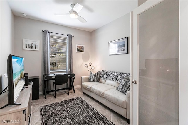 office space featuring ceiling fan, light tile patterned floors, and baseboards