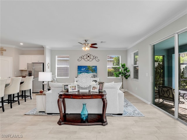 living room featuring ceiling fan and crown molding