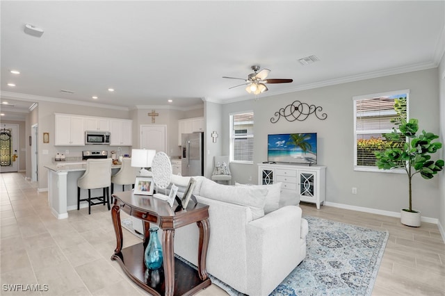 living room with ceiling fan and crown molding