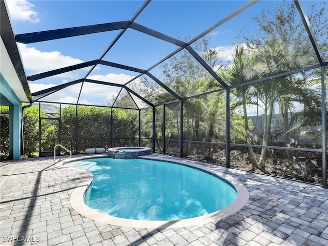 view of swimming pool with an in ground hot tub, glass enclosure, and a patio