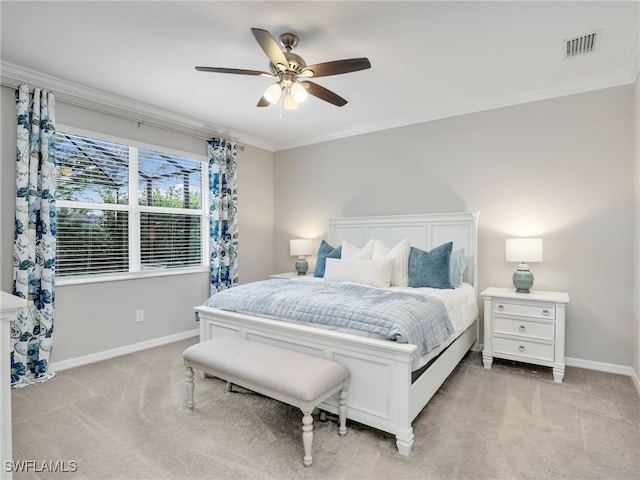 bedroom with ceiling fan, crown molding, and light colored carpet