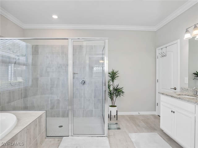 bathroom featuring shower with separate bathtub, crown molding, wood-type flooring, and vanity