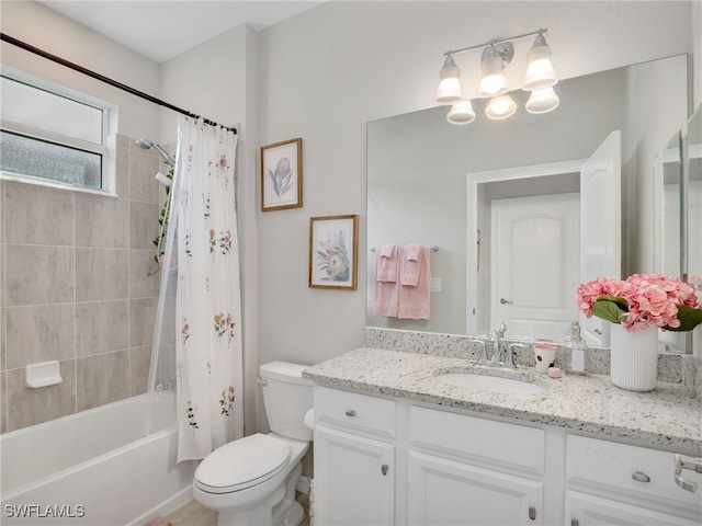 full bathroom with shower / bathtub combination with curtain, vanity, and toilet