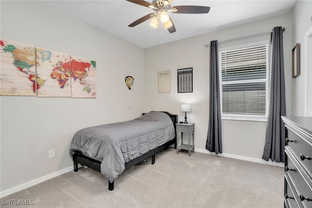 bedroom with ceiling fan and light carpet