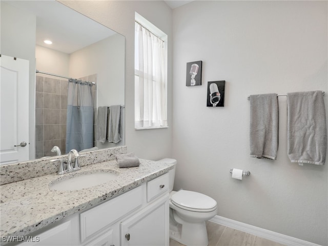 bathroom with toilet, a shower with shower curtain, and vanity