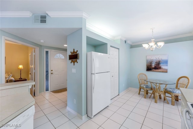 kitchen with crown molding, light tile patterned floors, white appliances, and a notable chandelier