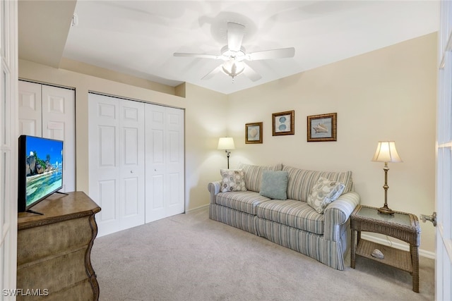 carpeted living room featuring ceiling fan