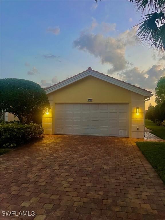 view of garage at dusk