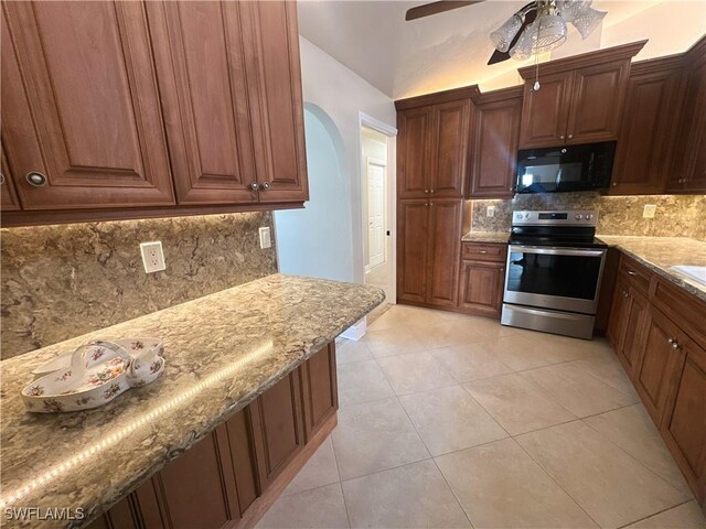 kitchen featuring backsplash, light tile patterned floors, ceiling fan, light stone countertops, and electric stove