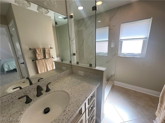 bathroom featuring tiled shower, vanity, and tile patterned floors