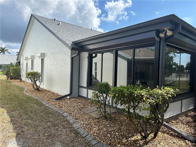 view of side of property featuring a sunroom