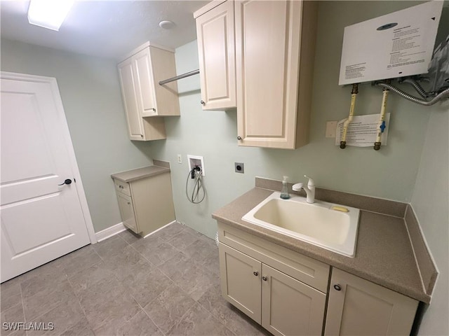 washroom with sink, water heater, cabinets, washer hookup, and hookup for an electric dryer