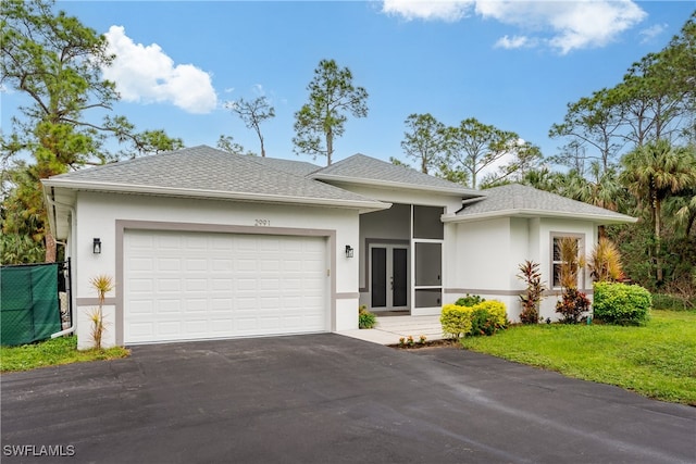 view of front facade with a garage and a front lawn